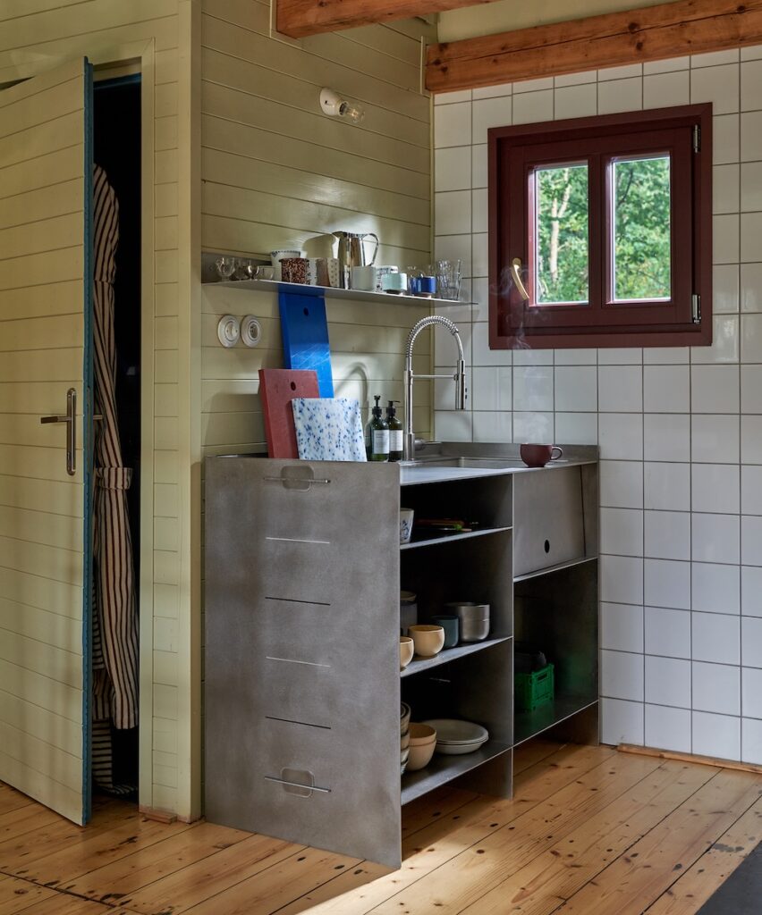 Custom stainless steel kitchen unit in a small cottage kitchen