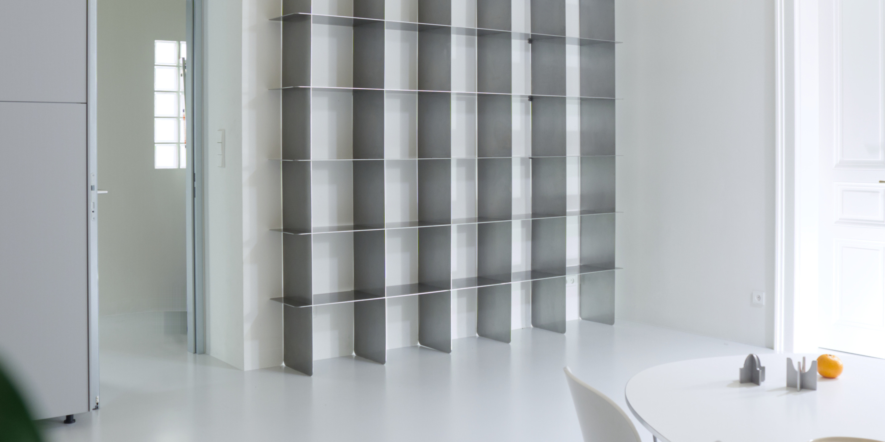 Mesh stainless steel bookcase made to measure for an apartment in Prague by inox système