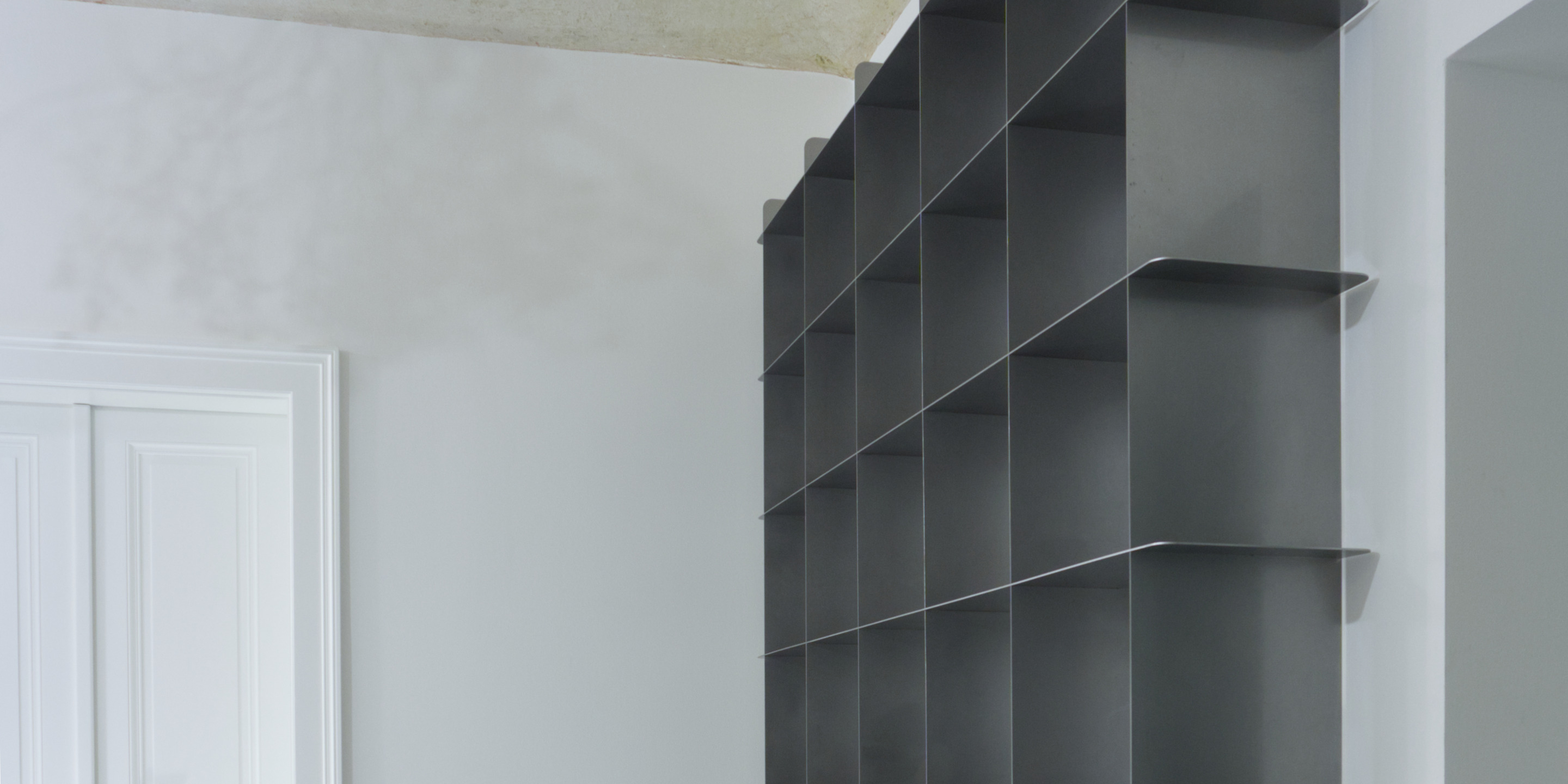 Mesh stainless steel bookcase made to measure for an apartment in Prague by inox système